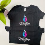 Black t-shirt with vibrant multicolored feather wildlife-inspired fashion celebrating natural beauty and cultural identity.